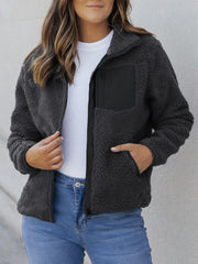Sherpa zip-up jacket in dark gray with black patch pocket and zipper details.