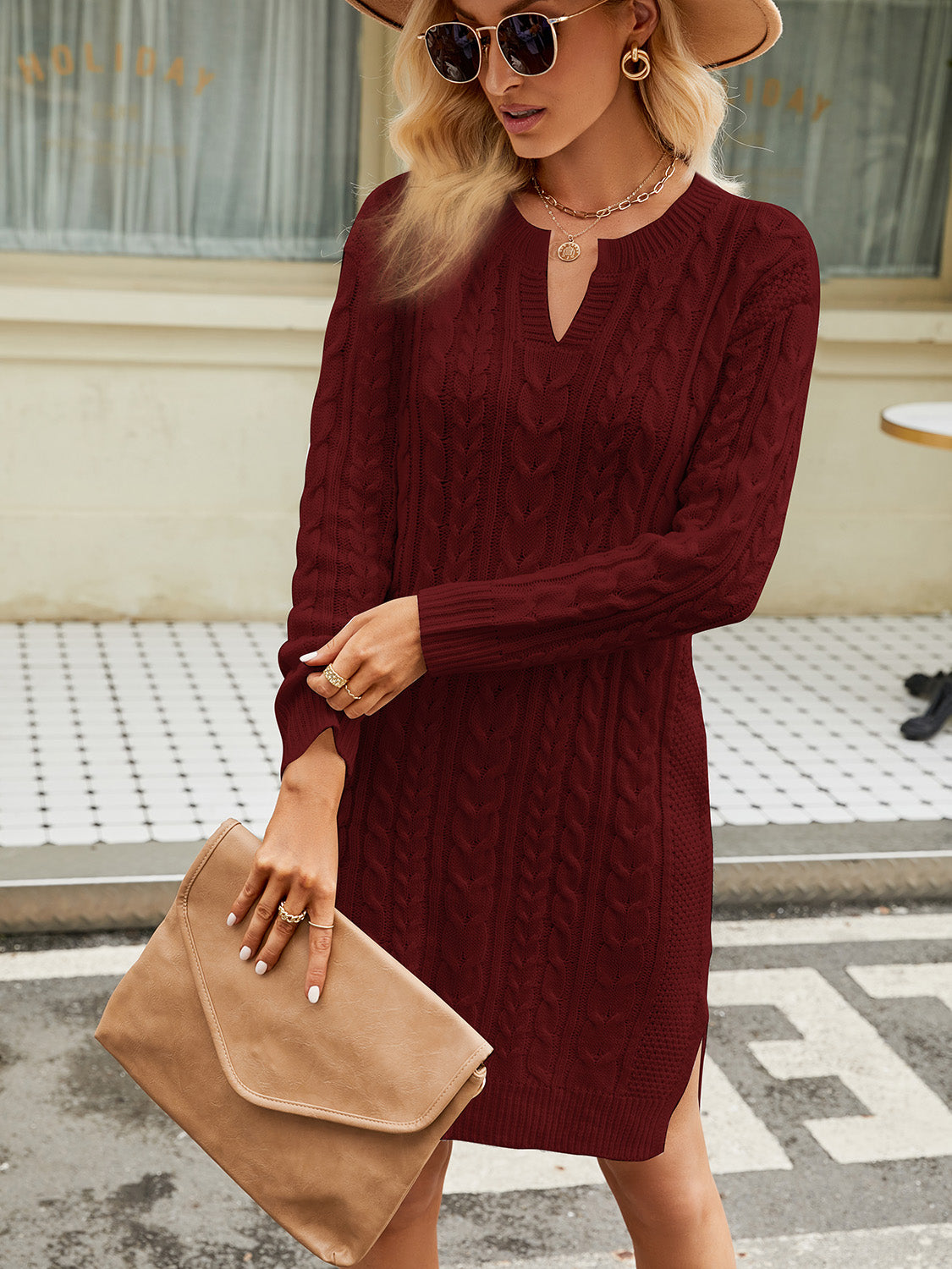 Wine cable knit sweater dress with keyhole neckline and side slits.