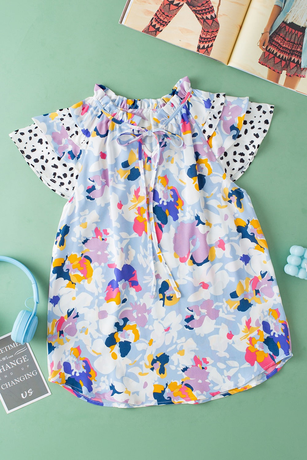 Dalmatian Trim Floral Print Blouse with tie neck and ruffled collar.