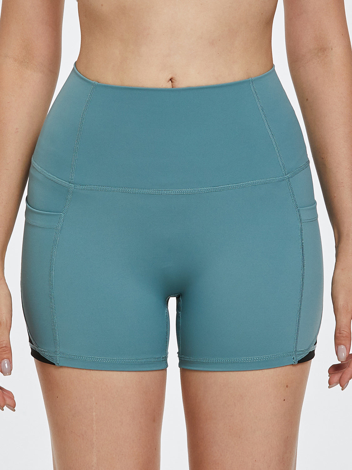 Turquoise activewear shorts with pockets and colorblock detail
