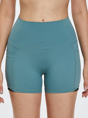 Turquoise activewear shorts with pockets and colorblock detail
