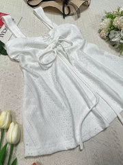 White eyelet camisole with drawstring detail and adjustable straps.