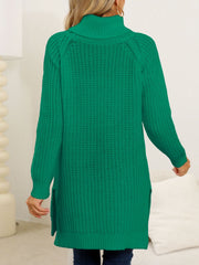 Dark green knit turtleneck sweater with asymmetric hemline and side slits.