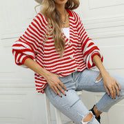 Red and white stripe knit cardigan with button-up front and bell sleeves.