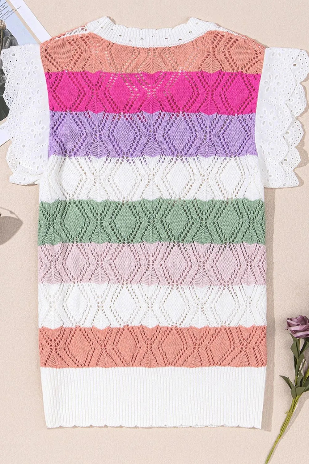 Rainbow crochet blouse with white eyelet flutter sleeves and diamond pattern.