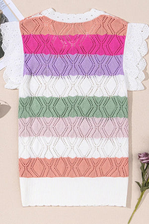 Rainbow crochet blouse with white eyelet flutter sleeves and diamond pattern.