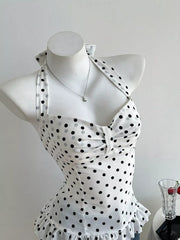 White polka dot halter cami with bow detail and ruffled hem.