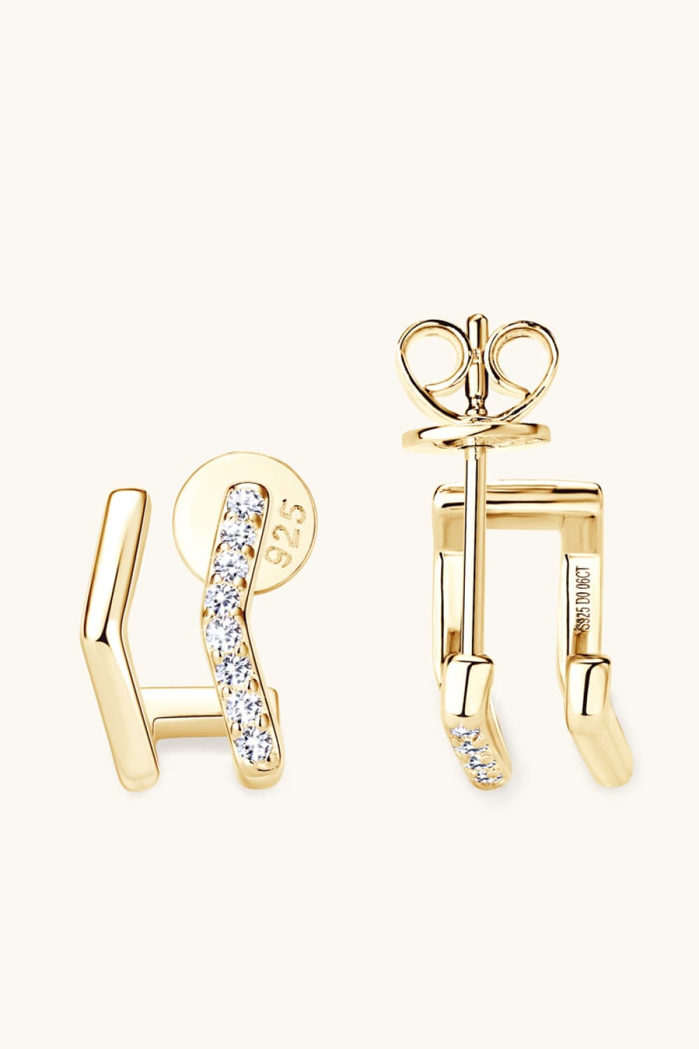 Geometric pavé ear jackets in gold with cubic zirconia accents.