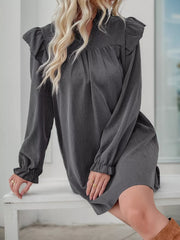 Dark gray ruffled notched sleeve dress with cinched cuffs and a gathered neckline.