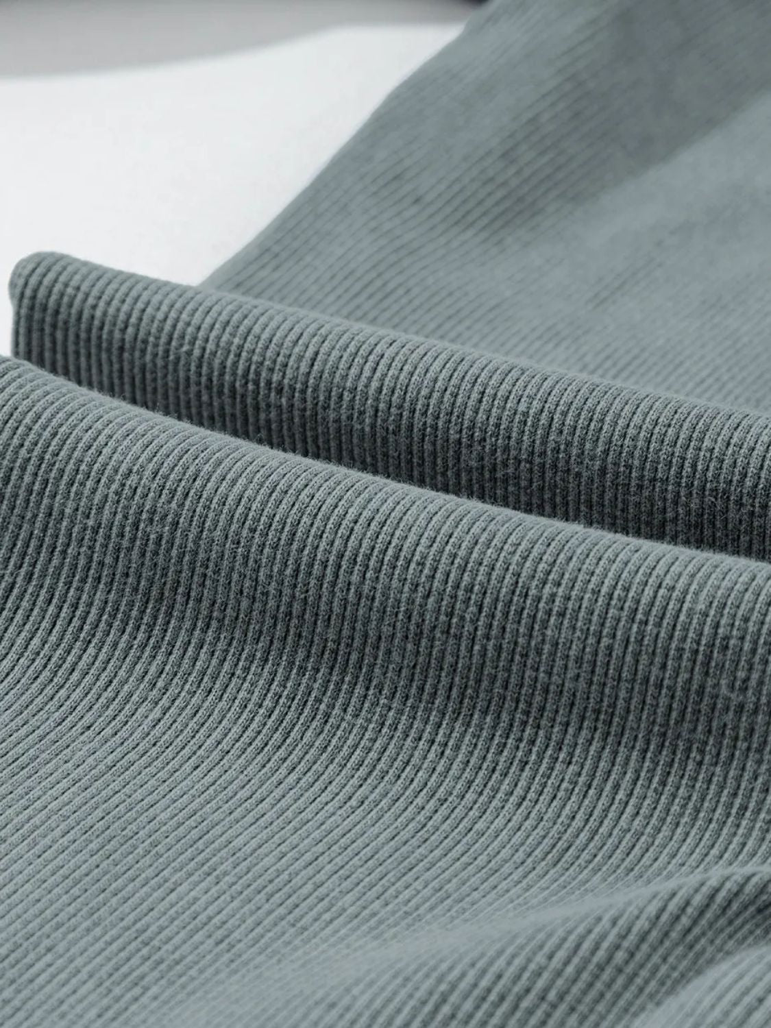 Textured ribbed leggings in dark gray, showing fabric detail.