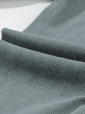 Textured ribbed leggings in dark gray, showing fabric detail.