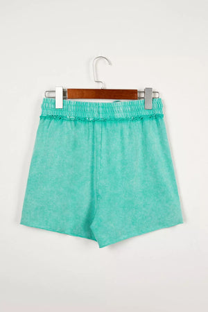 Mineral washed cotton drawstring shorts in aqua with ruffled elastic waist.