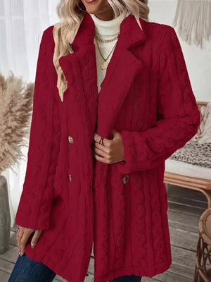 Red faux shearling double-breasted overcoat with cable knit texture and button closure.