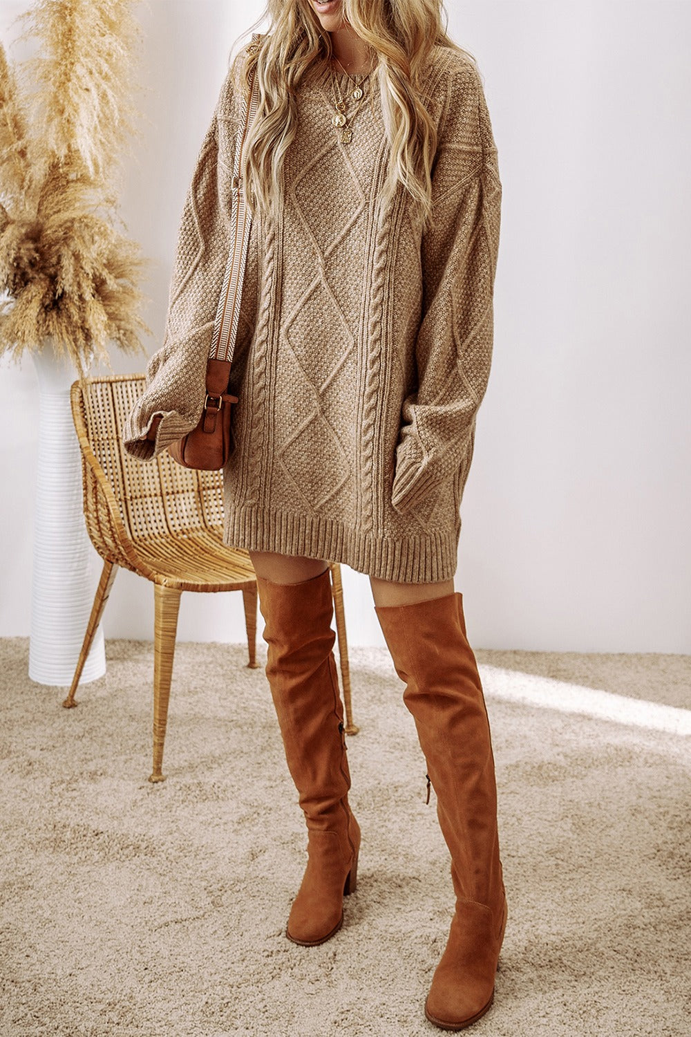 Tan cable knit sweater dress with diamond pattern, crew neck, long sleeves, and pockets.