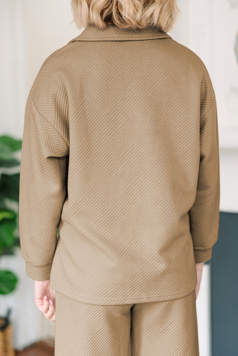 Tan textured polo set with wide-leg culottes and geometric pattern.
