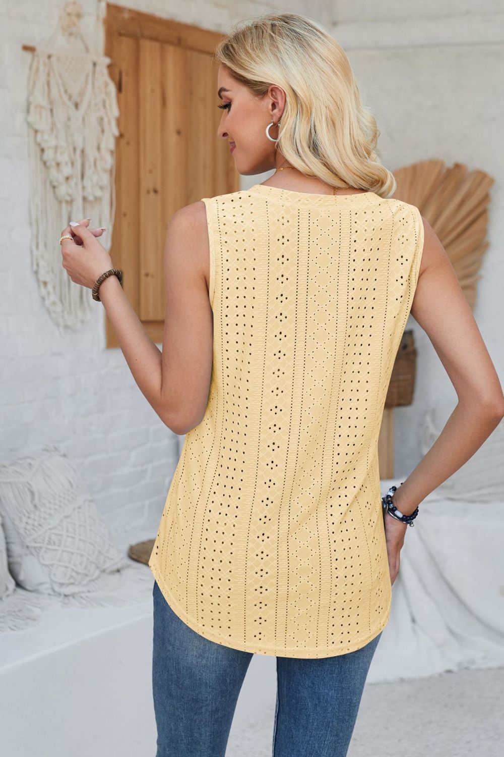 Light Yellow perforated sleeveless button-down top with eyelet details.