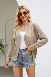 Khaki openwork knit button-down cardigan with V-neck and long sleeves, styled with a white tank and denim shorts.