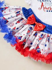 Baby outfit set with gnome and firework print skirt, red bow, and ruffled trim.