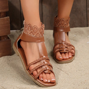 Caramel lace-trimmed gladiator sandals with braided straps and ankle detail.