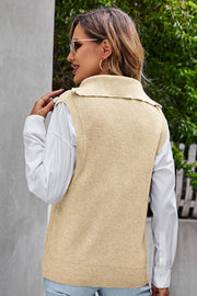 Tan ribbed knit vest with zip-neck and collar, layered over a white shirt.