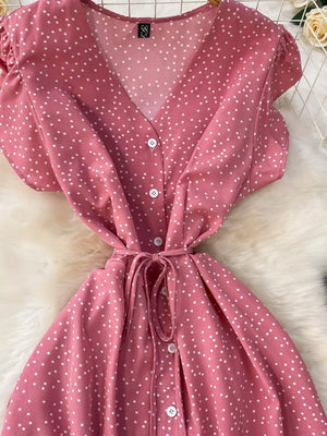 Pink polka dot maxi dress with belt, V-neck, button front, short sleeves.
