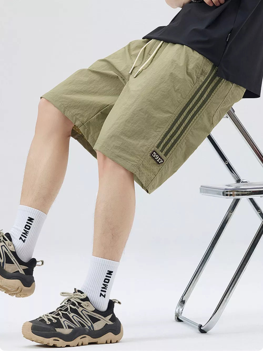 Light Green casual drawstring shorts with sporty side stripes and a number detail.
