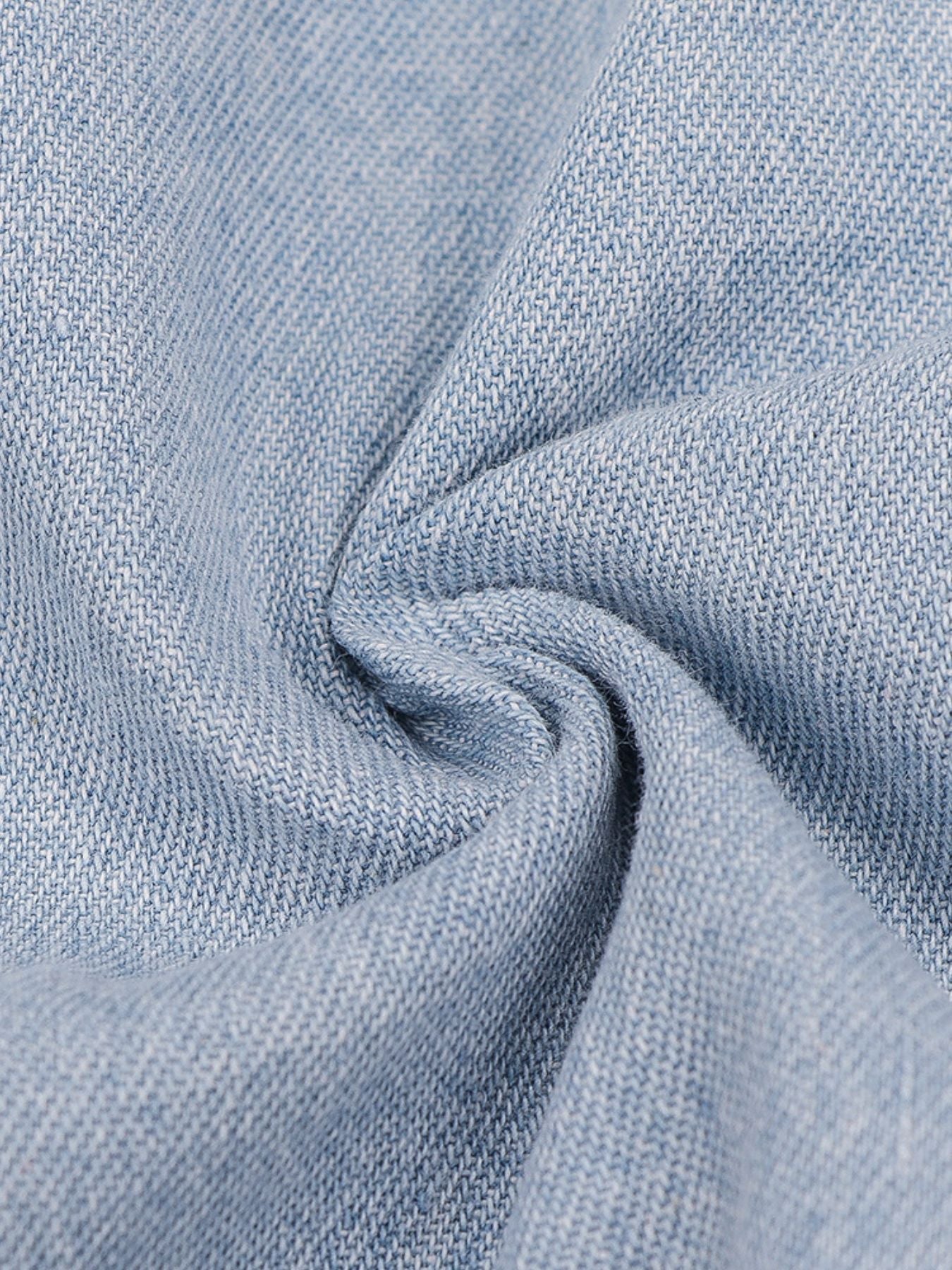 Light wash denim mini dress with a textured weave and a zipper front detail.