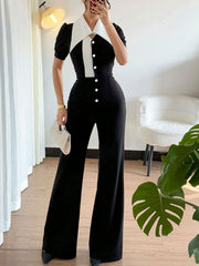 Button-down wide leg jumpsuit in black and white with a pointed collar and short sleeves.
