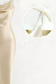 Pearl-embellished cowl neck satin maxi dress in champagne with delicate pearl strap detail.