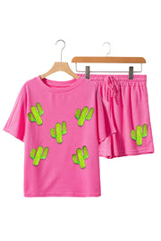 Pink waffle knit loungewear set with cactus appliqué, featuring a short sleeve top and drawstring shorts.