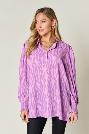 Lavender zebra print blouse with shirred cuffs and a collared neckline.