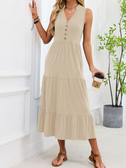 Apricot tiered midi dress with notched V-neck and decorative buttons.