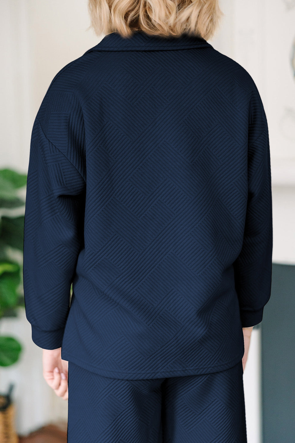 Navy textured polo set with wide-leg culottes and a geometric pattern.