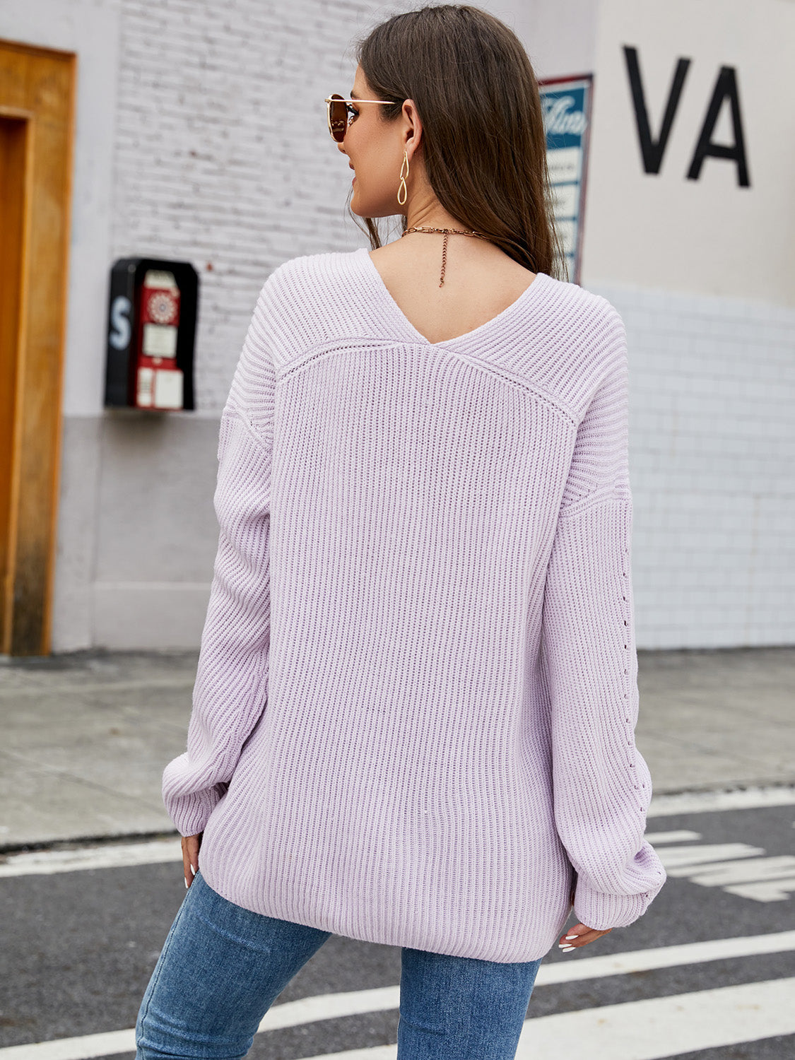 Lilac ribbed knit sweater with V-neck and subtle sleeve detail.