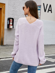Lilac ribbed knit sweater with V-neck and subtle sleeve detail.