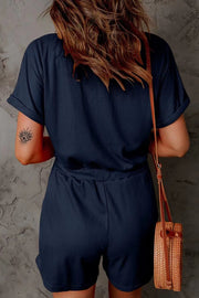 Dark blue ribbed V-neck romper with cuffed short sleeves and drawstring waist.