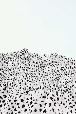 White dalmatian print shirred yoke blouse with ruffled neckline detail.