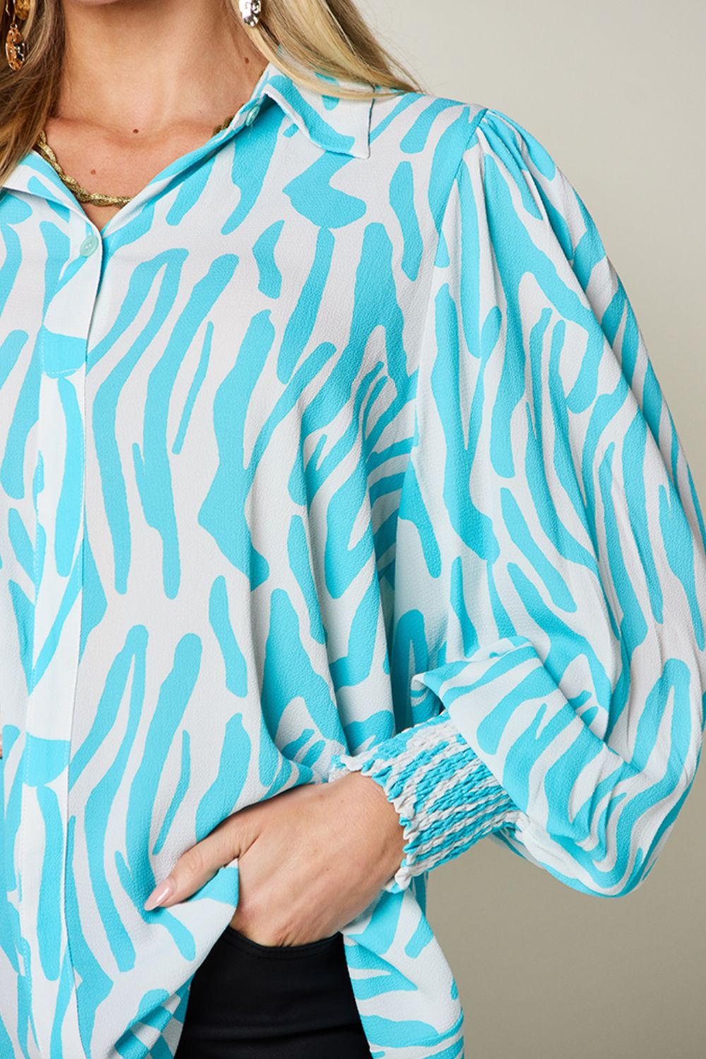 Tiffany blue zebra print blouse with shirred cuffs and puff sleeves.