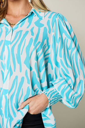 Tiffany blue zebra print blouse with shirred cuffs and puff sleeves.