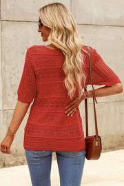 Rust openwork knit tee with short sleeves and varied stitch patterns.