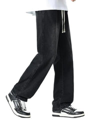 Relaxed wide leg black cotton jeans with drawstring waist and visible stitching detail.