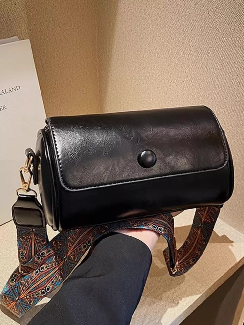 Black leather crossbody bag with ethnic patterned strap
