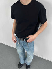 Black crew neck t-shirt with short sleeves, made of comfortable cotton.