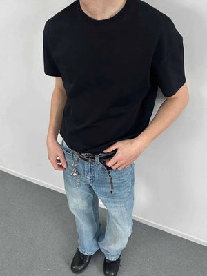 Black crew neck t-shirt with short sleeves, made of comfortable cotton.