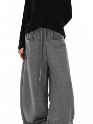Men's gray wide-leg sweatpants with drawstring and pockets.