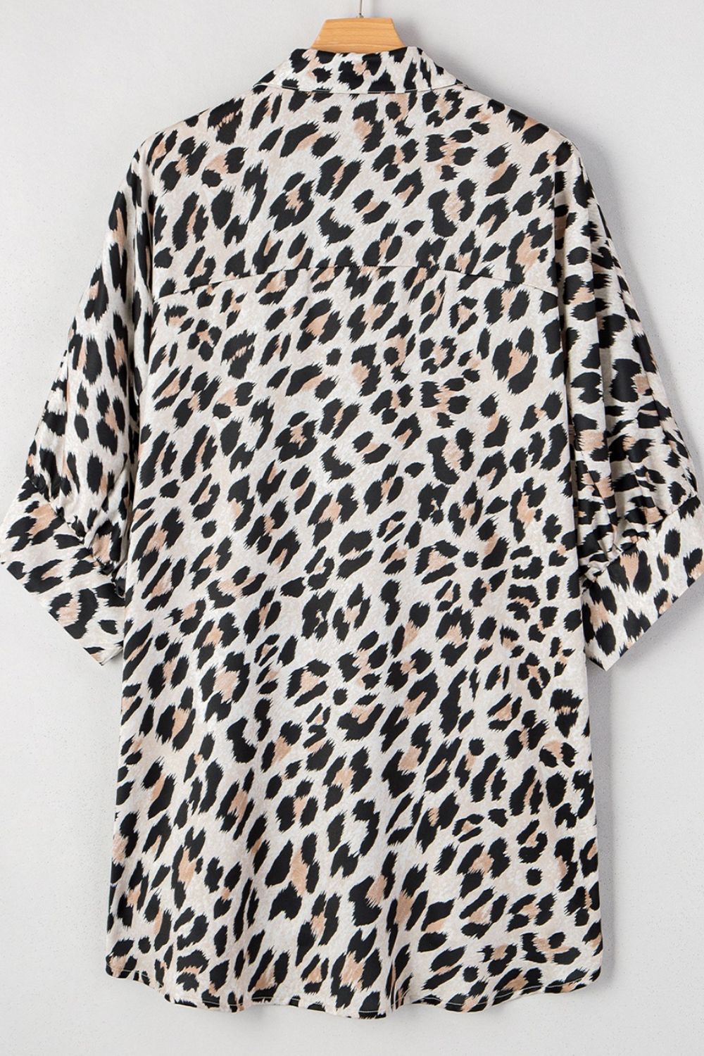 Leopard print oversized button-down blouse with cuffed sleeves.