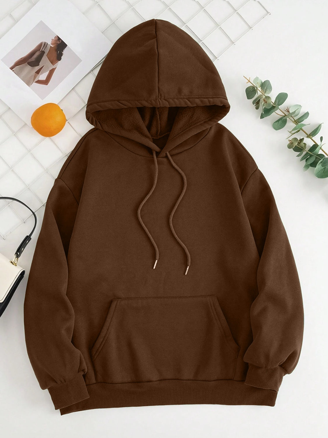 Oversized chocolate brown hoodie with pouch pocket and drawstring hood.