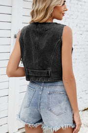 Black denim cropped vest with button front and pocket detail.