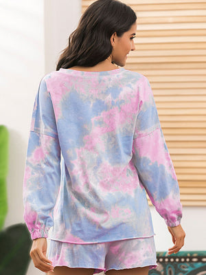 Pastel tie-dye lounge set with pink and blue colors, long sleeves, and shorts.