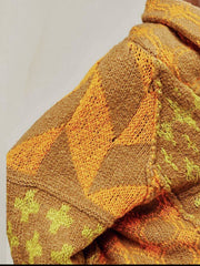 Geometric patchwork knit cardigan in brown with orange and yellow patterns.